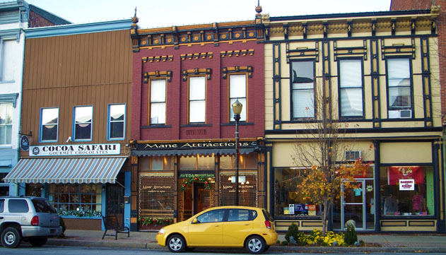 100 Block of West Main Street view Madison Indiana. Cocoa Safari Chocolates gourmet hand dipped chocolates, international and suger free chocolates, and chocolate covered coffee beans. Mane Attractions hair and beauty salon. Suntime Printing screen printing t-shirts, pet the dog, but don’t touch the bike.