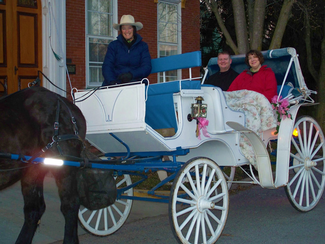 Couple on Broomtail carriage ride, in front of Azalea Manor Bed and Breakfast, in Madison Historic District, downtown Madison Indiana on West Main Street.