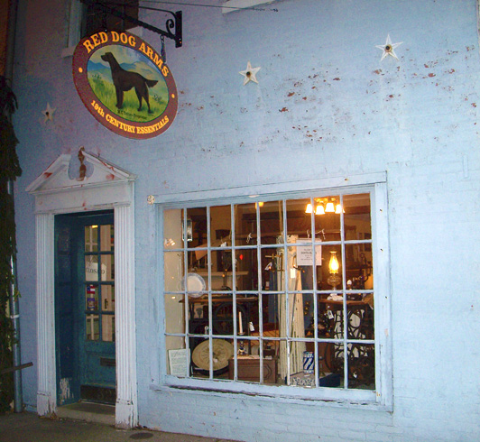 steet view of Red Dog Arms store front, providing 19th century tools for survival hand crafted weapons, clothing, uniforms.