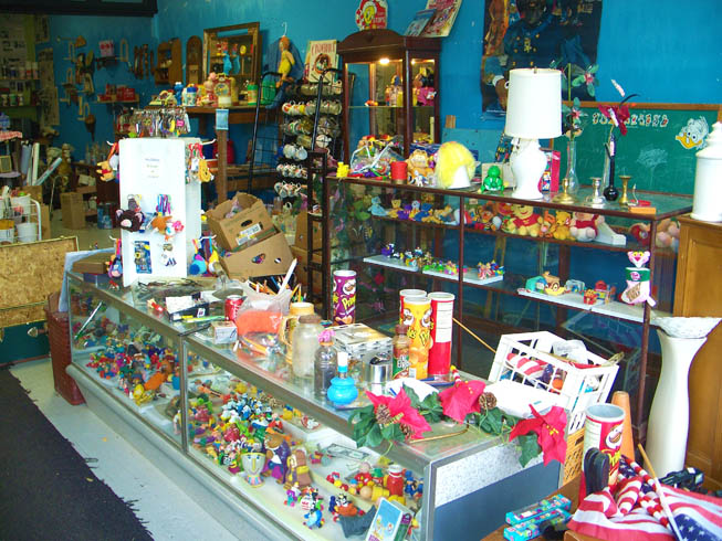 picture of Items include cameras, lamps, watches, antique jars, mugs, pencils, pens, writting instruments, pez dispensers, eye glasses, key chains, stuffed animals, winnie the pooh, mason morter tools, miniture toy figurines, potatoe head, beauty and the beast, disney figures, very old antique toys, 40 years very old, stuffed animals, lamps, flower holders, candle holders, miniture stuffed animals, Bert and Ernie dolls, the pink panther, miniture U.S. flags, baskets, pedestals, mirrors, wall mounted shelves, wall mounted light holders, wall mounted candlestick holders, toy clocks, large toy boxes and toy chests,  ALL ITEMS FOR SALE